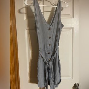 V-neck button up romper with tie around the waist.